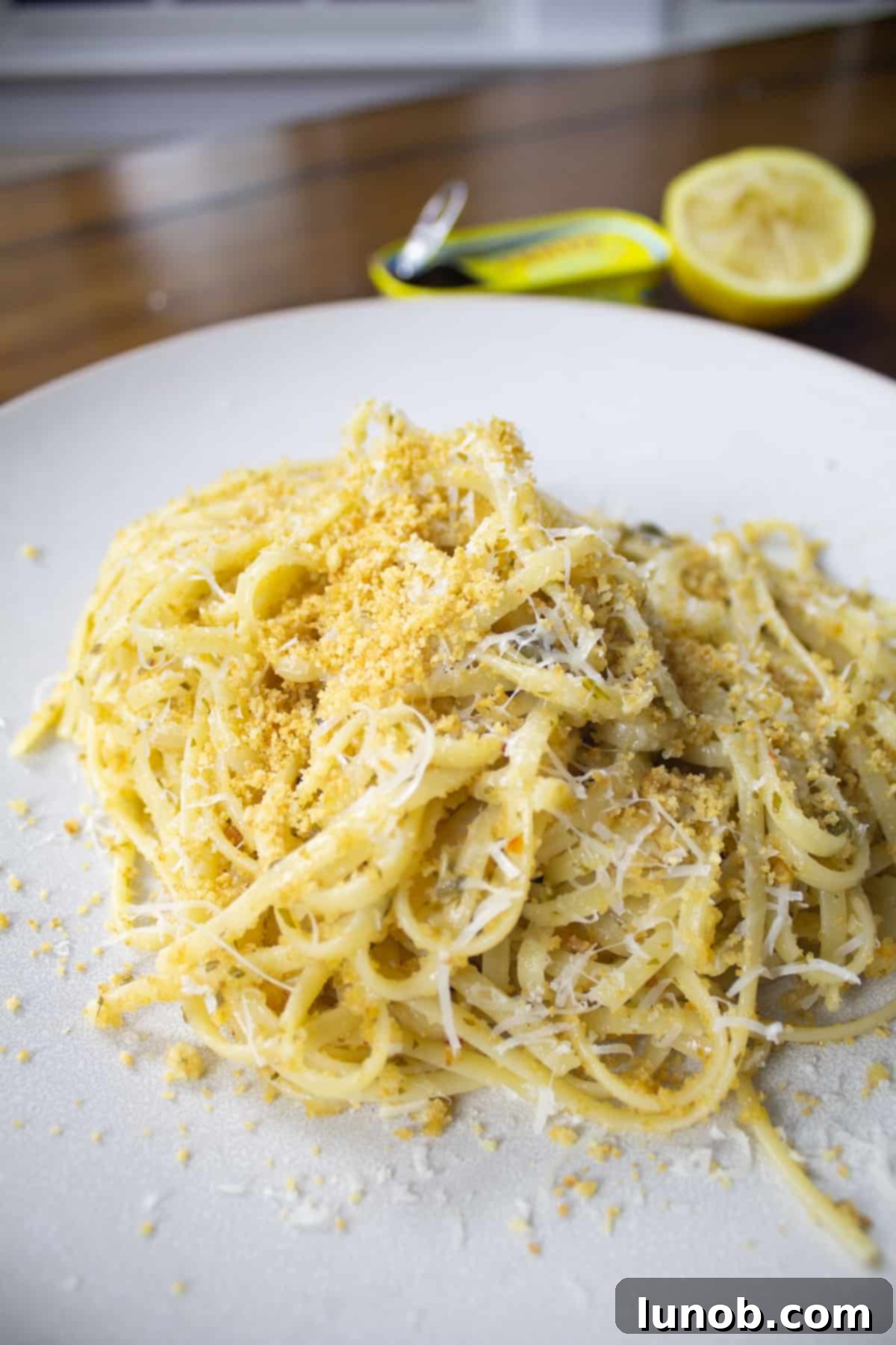 Close up of lemon garlic anchovy linguine with golden toasted bread crumbs, garnished with fresh parsley