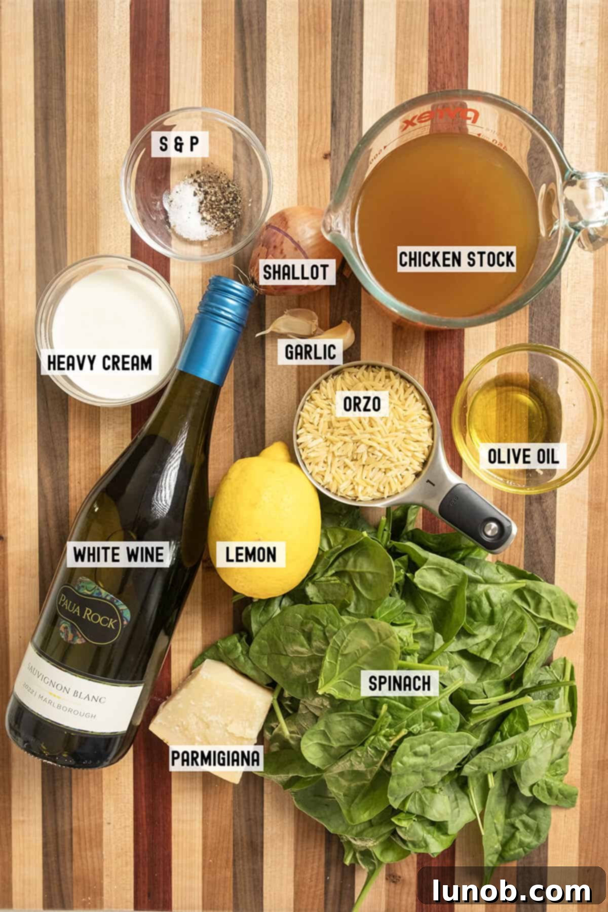 Bright Lemon Spinach Orzo 3 Fresh ingredients laid out for lemon spinach orzo: chicken broth, parmesan, fresh spinach, lemons, shallots, and garlic.
