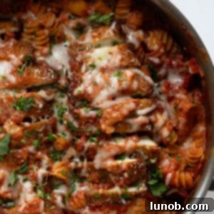 Velvety Chicken Parmesan Pasta 10 creamy chicken parmesan pasta in a skillet