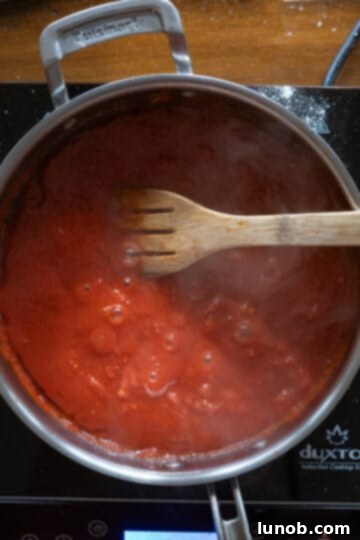 Velvety Chicken Parmesan Pasta 6 sauce simmering