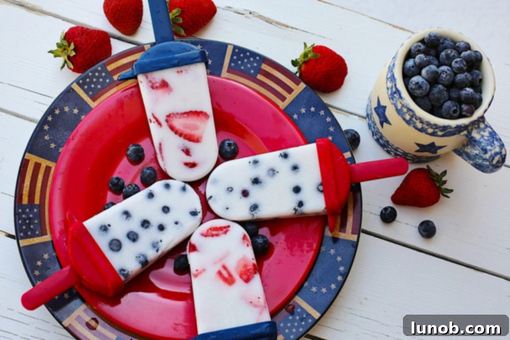 A festive spread of red, white, and blue desserts and dishes for a patriotic celebration.