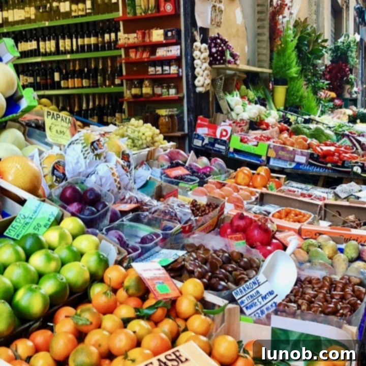 A vibrant market stall overflowing with fresh fruits and vegetables in Bologna, Italy, showcasing the abundance of seasonal produce.