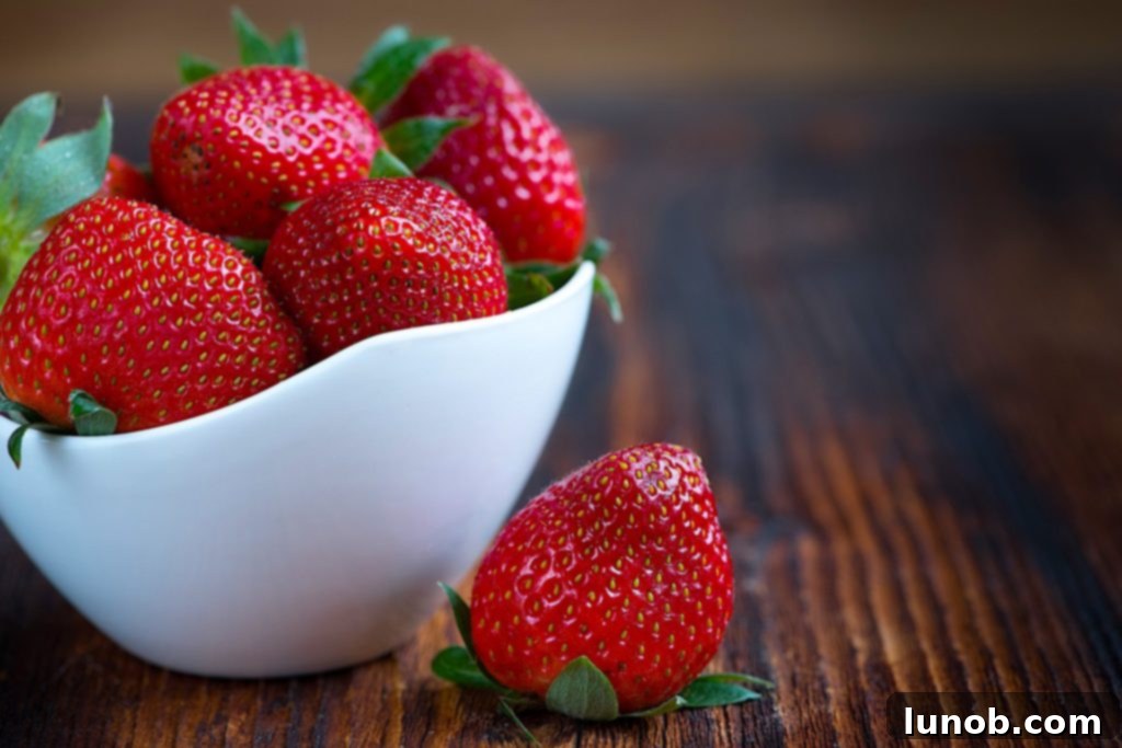 Hand picking fresh strawberries from a farm
