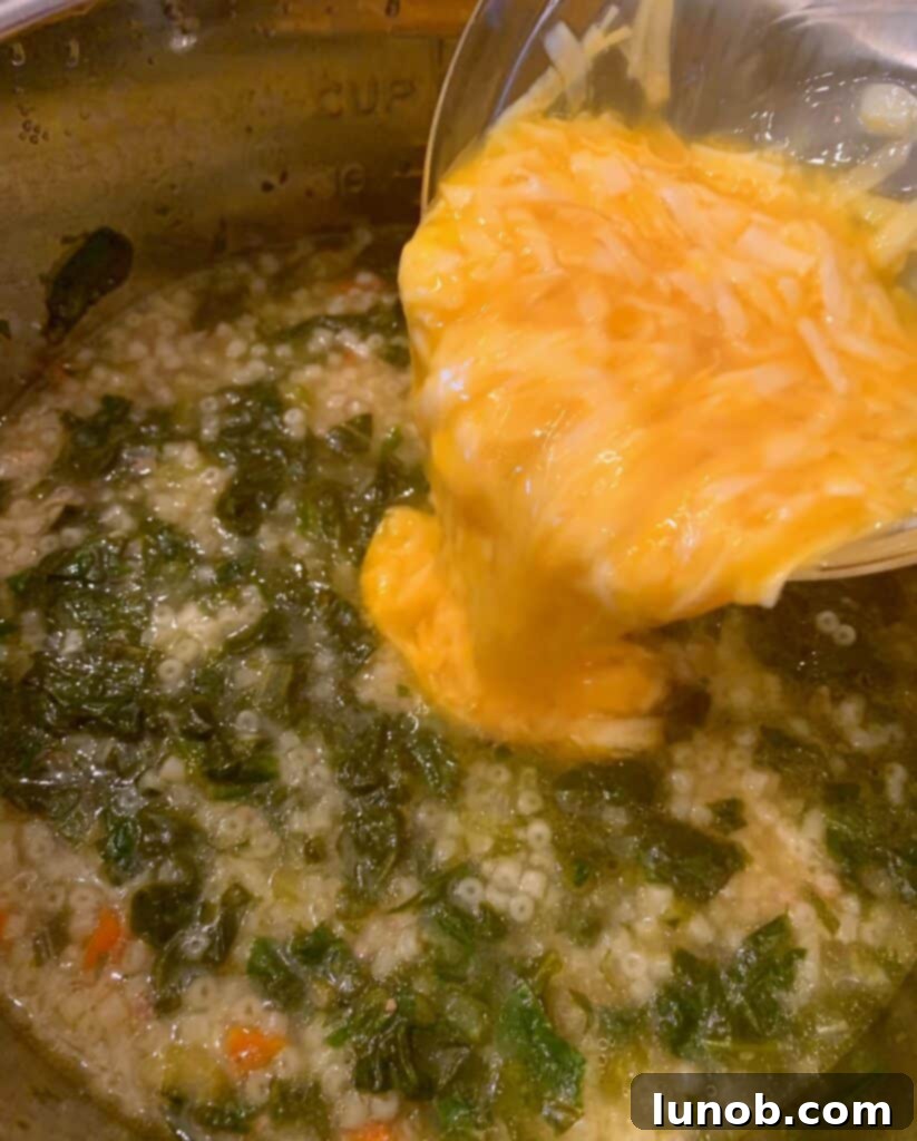Delicate strings of egg and cheese visible in the Instant Pot Italian Wedding Soup, indicating a perfectly executed egg swirl.