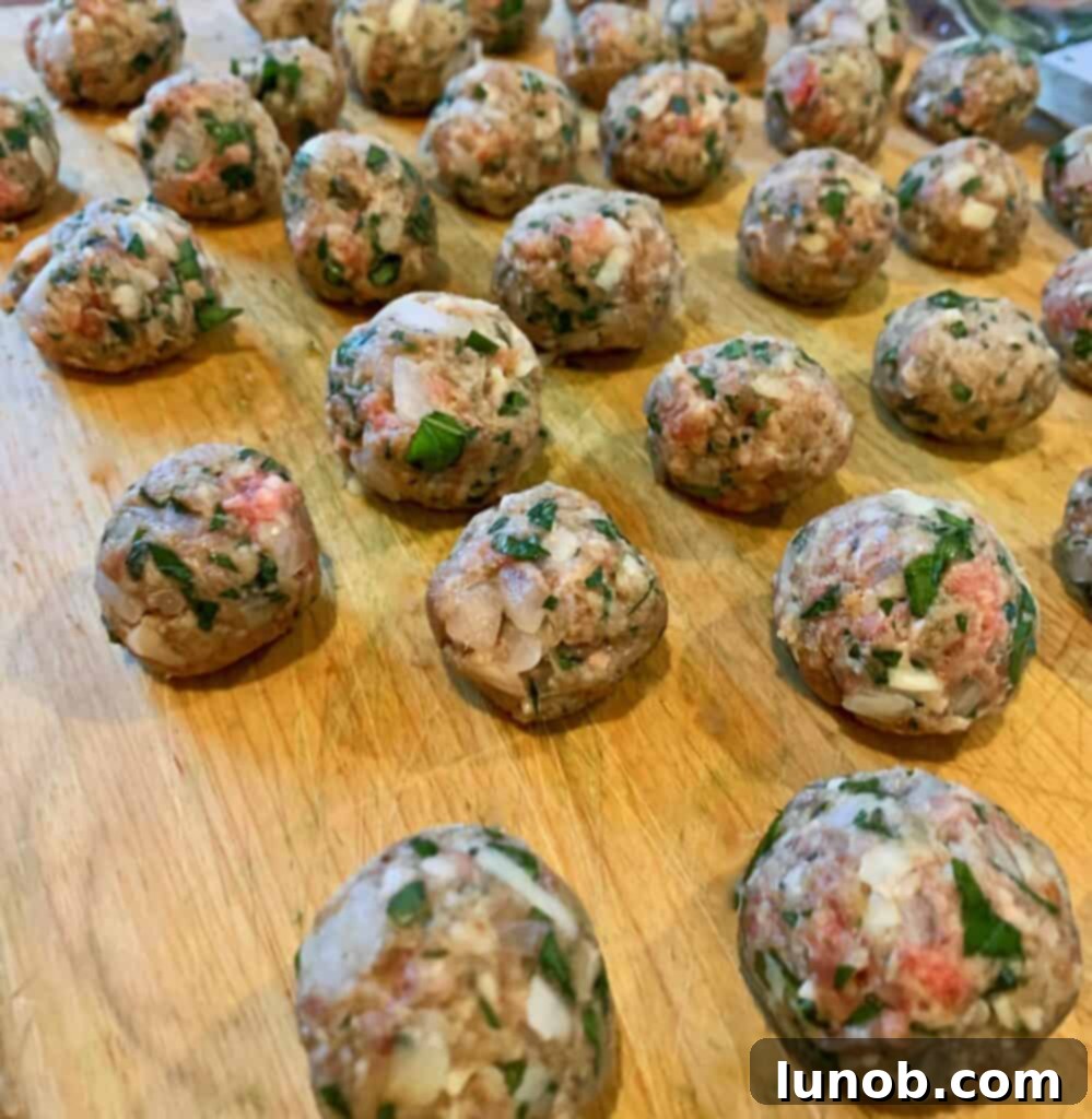 Browning homemade meatballs in an Instant Pot for Italian Wedding Soup, enhancing their flavor and texture before adding broth and vegetables.