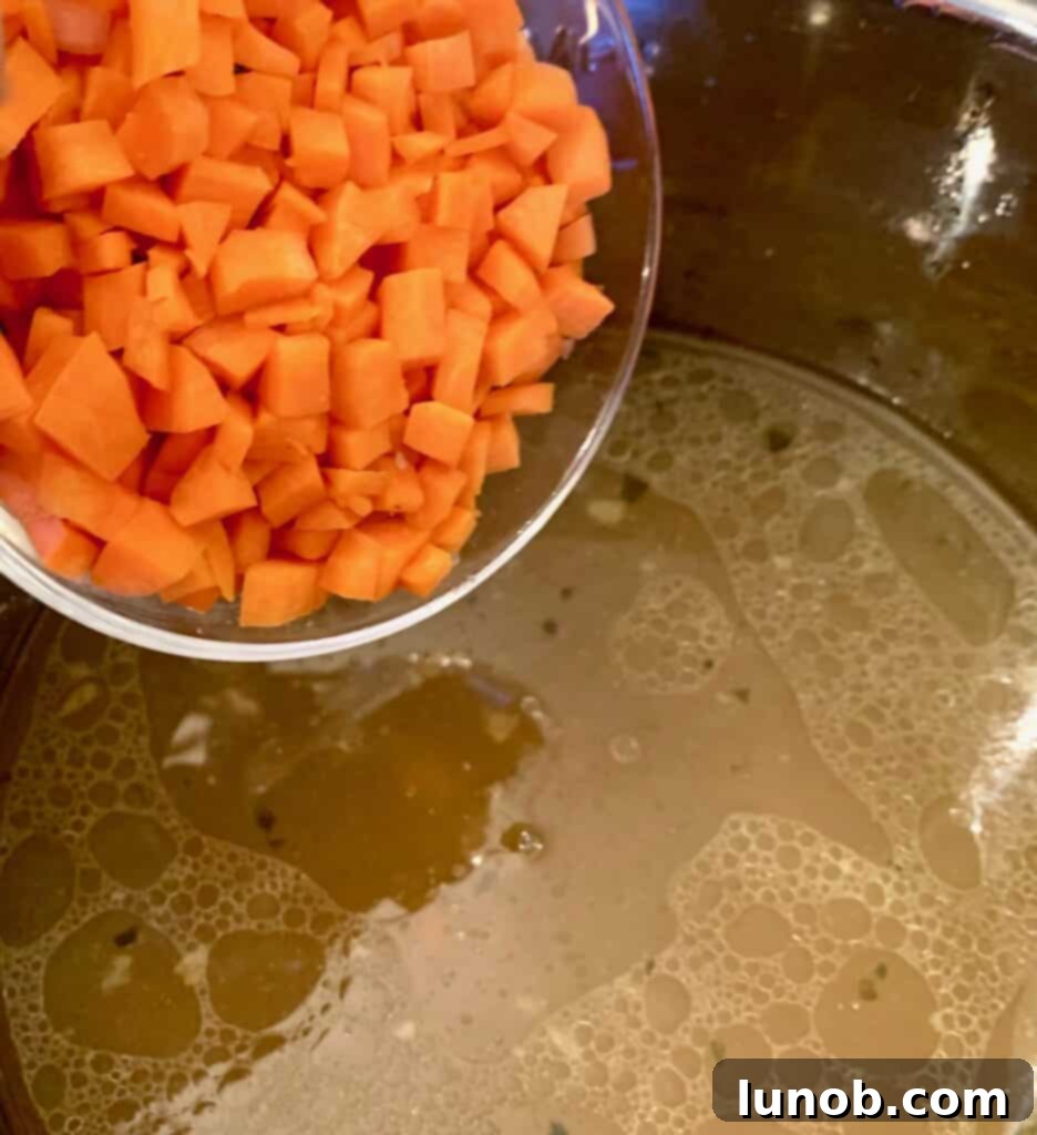 A large chunk of Parmigiano cheese rind added to the Instant Pot for Italian Wedding Soup, a secret ingredient to deepen its flavor.