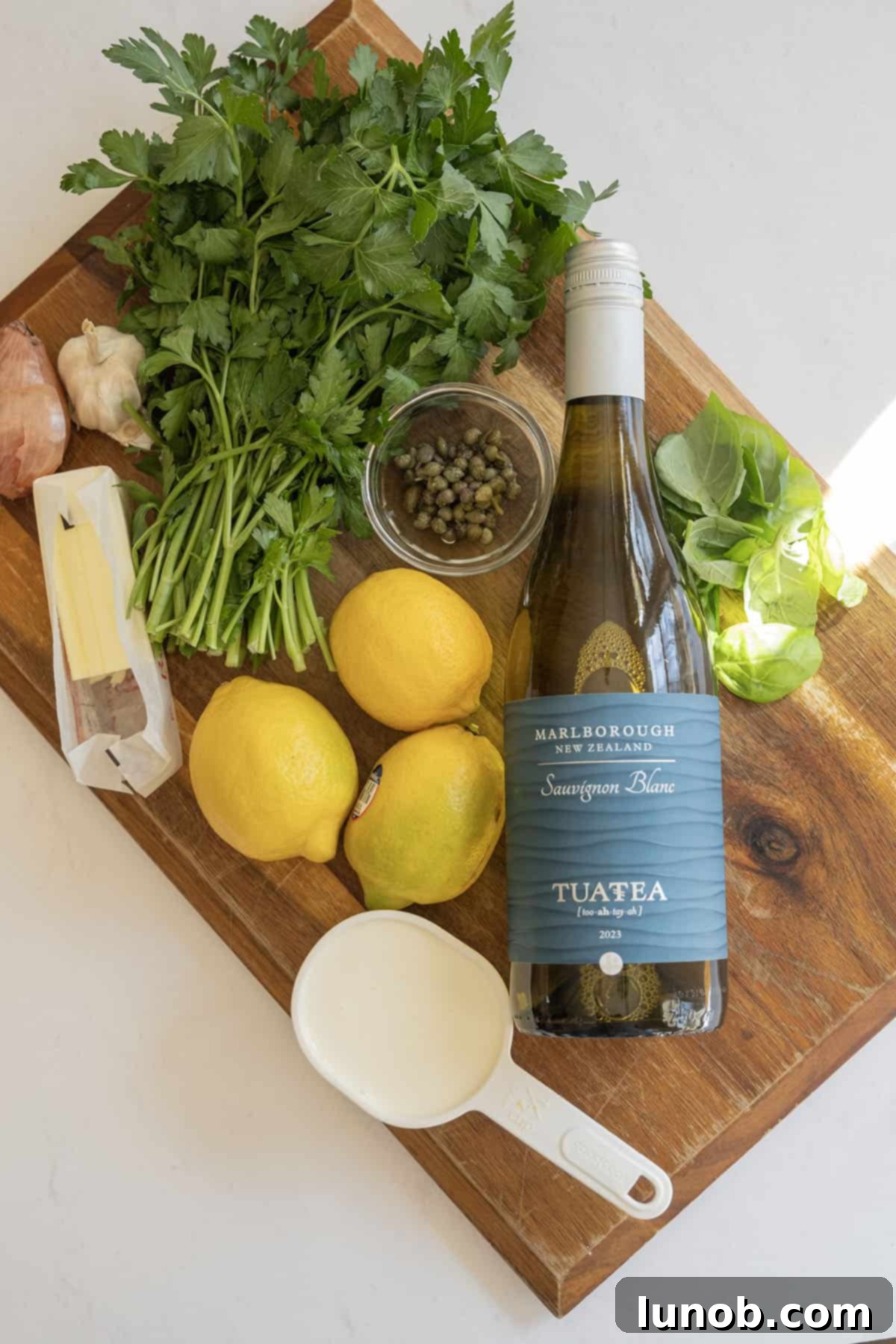 Velvety Lemon Sauce 3 Ingredients for making a delicious white wine lemon sauce laid out on a table