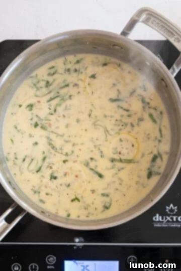 Velvety Lemon Sauce 9 Creamy lemon sauce gently simmering in a pan