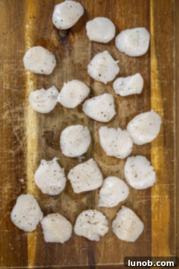 seasoning scallops with salt and pepper