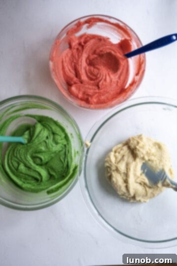 Cake batter with red and green food coloring added to separate bowls