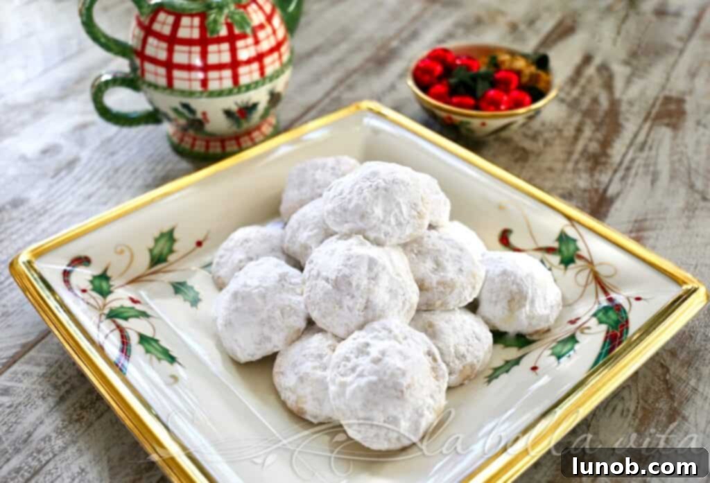 Decadent Nutella Surprise Snowballs 3 Close-up of a single Nutella Stuffed Snowball Cookie, revealing its soft powdered sugar coating