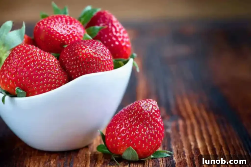 Close-up of fresh strawberries in a bowl, highlighting their vibrant red color