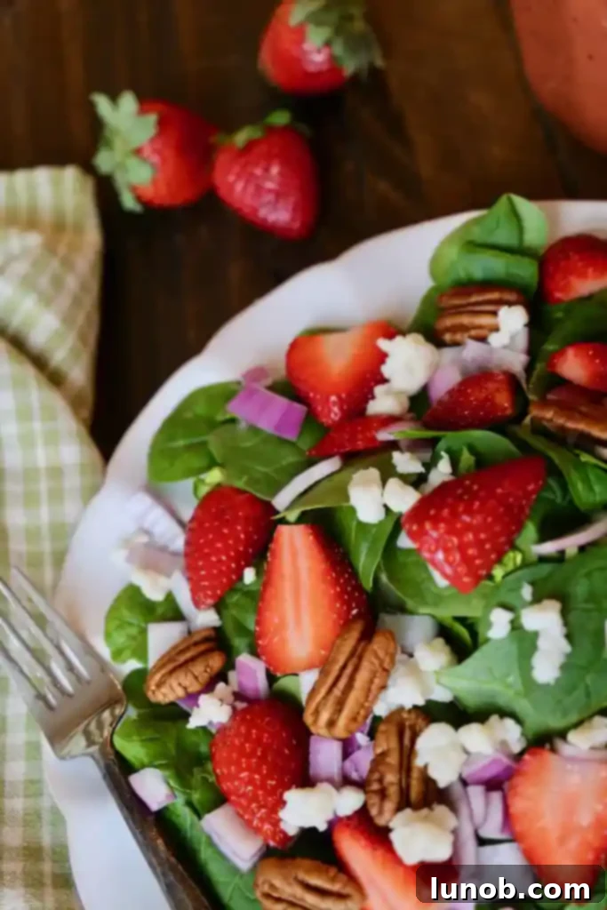 Assembled Strawberry Spinach Salad with dressing on the side