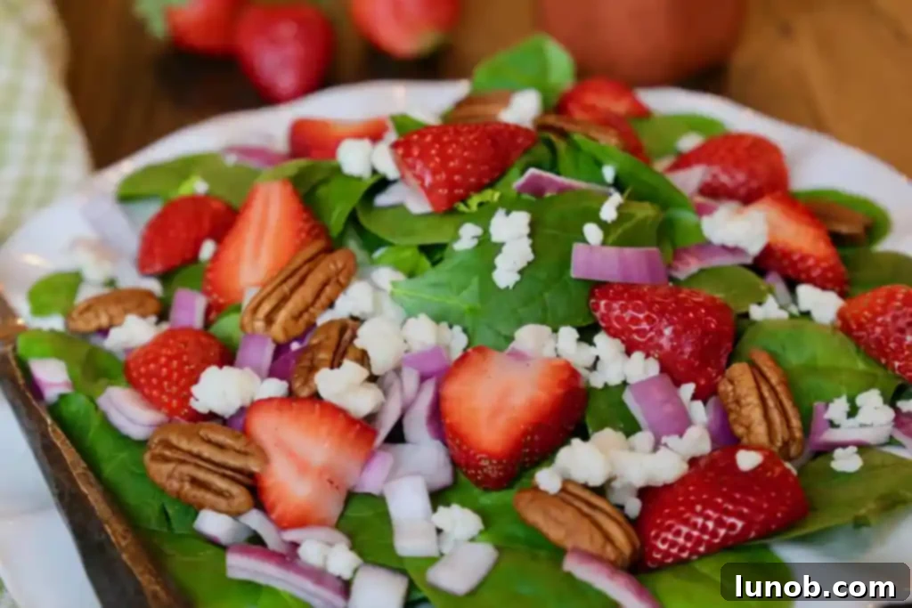 Strawberry Spinach Salad with Strawberry Balsamic Vinaigrette in a serving bowl