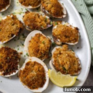 Classic Italian Stuffed Clams 11 Baked clams on a plate.