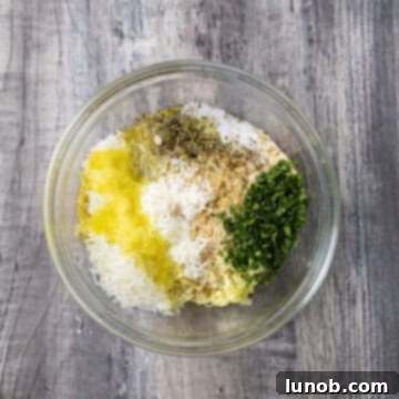 Classic Italian Stuffed Clams 4 Breadcrumbs, parmesan, parsley, salt, pepper, lemon juice, and minced garlic combined in a bowl.