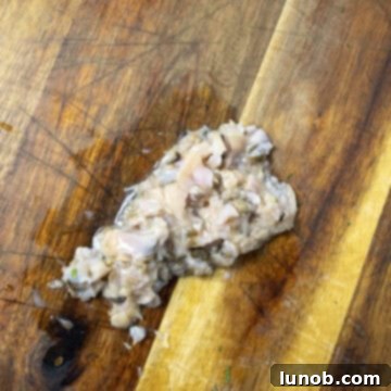 Classic Italian Stuffed Clams 5 Roughly chopped clams on a cutting board.