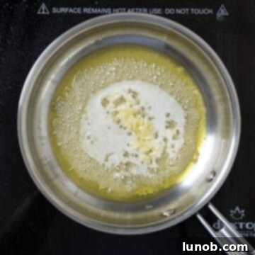 Classic Italian Stuffed Clams 7 Olive oil, lemon, garlic, and white wine simmering in a pan.