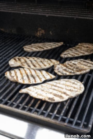 Zesty Mediterranean Chicken Pocket 6 Grilled chicken breast with visible grill marks resting on a cutting board.