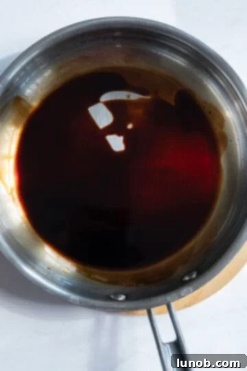 Zesty Mediterranean Chicken Pocket 7 Balsamic vinegar simmering in a small pan, reducing to a glaze.