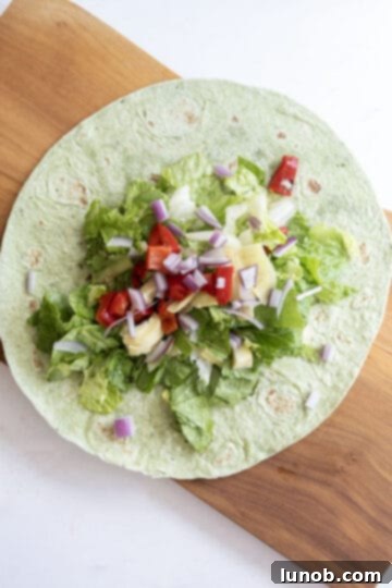 Zesty Mediterranean Chicken Pocket 8 A large tortilla wrap filled with fresh romaine lettuce, chopped roasted red peppers, artichoke hearts, and red onion, before adding chicken and feta.