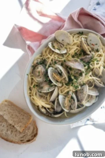 A serving of linguine with clams in a light white wine sauce.