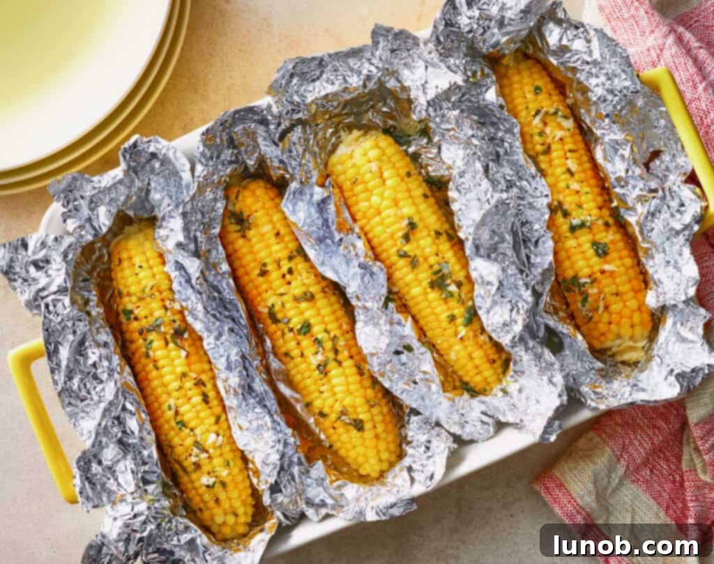 Grilled corn with some herbs and a side of cheese.