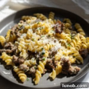 Rustic Sausage and Fennel Pasta 10 A vibrant bowl of Sausage and Fennel Pasta, showcasing the fusilli, browned sausage, and tender fennel, garnished with fresh herbs and grated cheese.