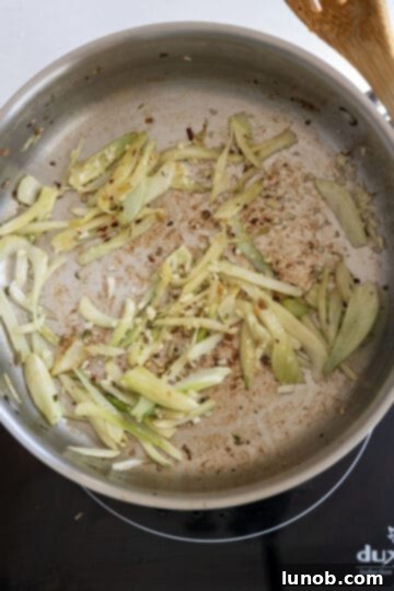 Rustic Sausage and Fennel Pasta 5 Thinly sliced fresh fennel being sautéed with minced garlic and crushed red pepper flakes.