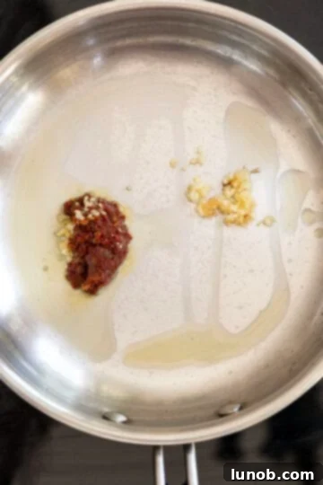 Smoky Chipotle BBQ Sauce 6 garlic and chipotle pepper in a pan