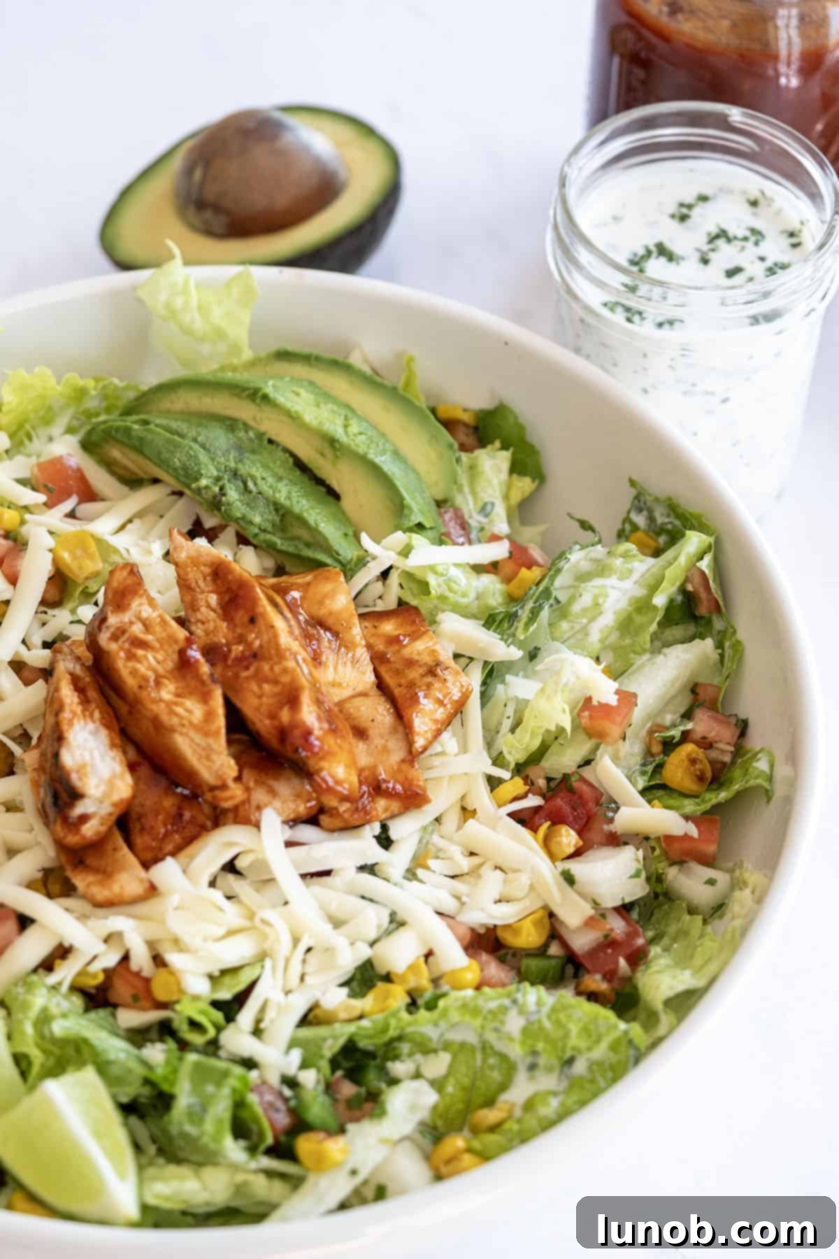 Zesty Chipotle BBQ Chicken Salad 2 Vibrant Chipotle BBQ Chicken Salad with grilled chicken, roasted corn, avocado, and cilantro lime ranch dressing, presented beautifully on a platter.