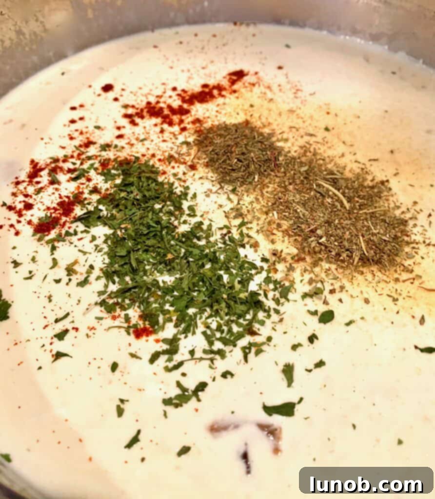 Turkey Tetrazzini: Cheesy Italian Delight with Crispy Garlic Butter Topping 13 Adding Italian seasoning, thyme, paprika, and dried parsley to the sauce