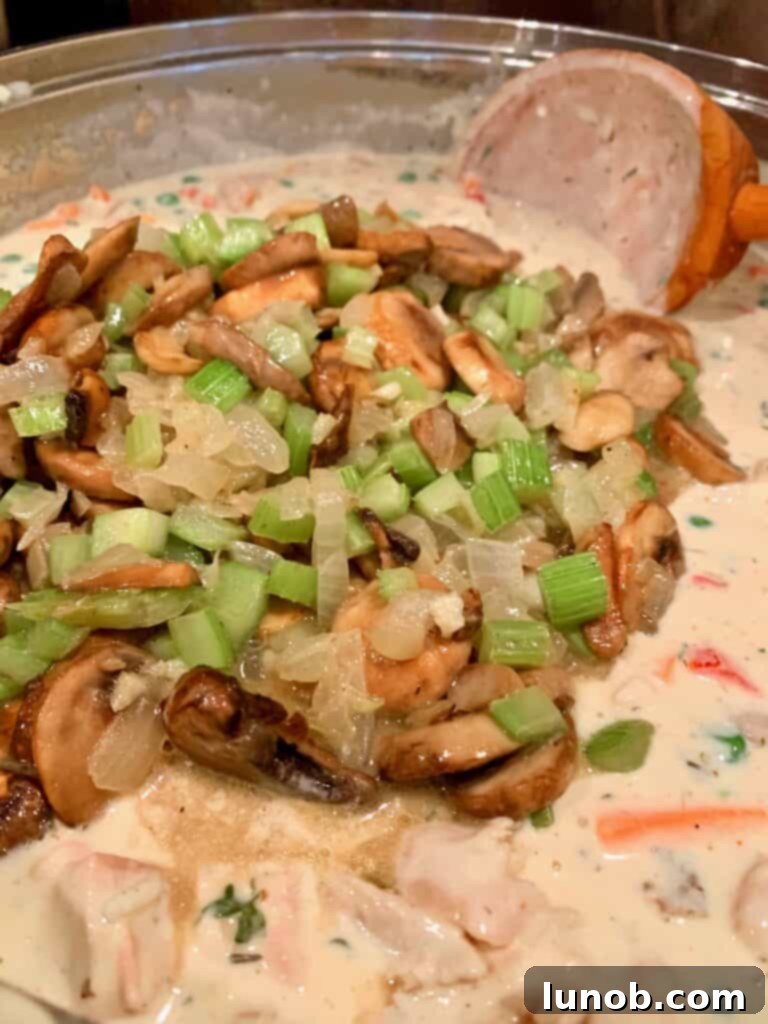 Turkey Tetrazzini: Cheesy Italian Delight with Crispy Garlic Butter Topping 19 Returning the sautéed mushroom mixture to the Tetrazzini sauce