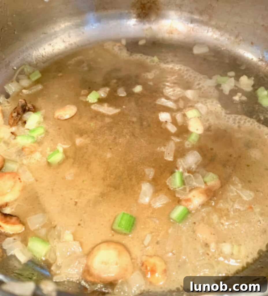 Turkey Tetrazzini: Cheesy Italian Delight with Crispy Garlic Butter Topping 8 Deglazing the pan with cooking sherry after sautéing vegetables