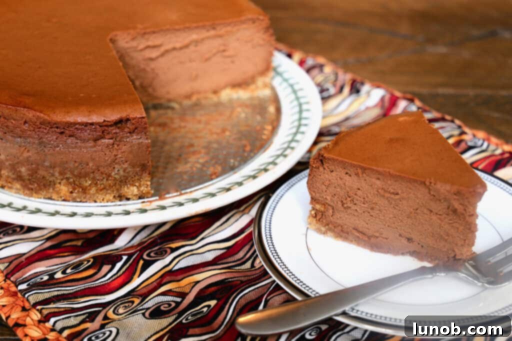Garnished Chocolate Espresso Mousse Cheesecake with whipped cream and raspberries