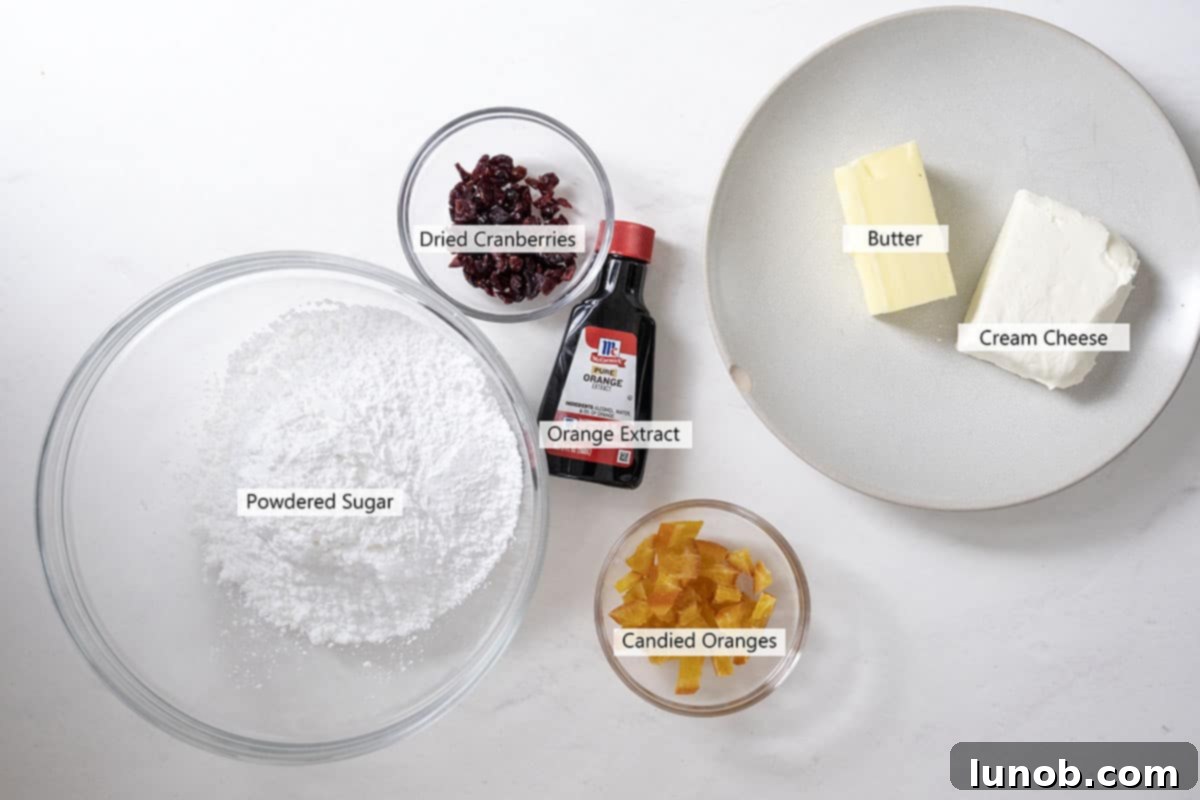 Ingredients for the creamy orange frosting, including cream cheese, butter, powdered sugar, and orange extract.
