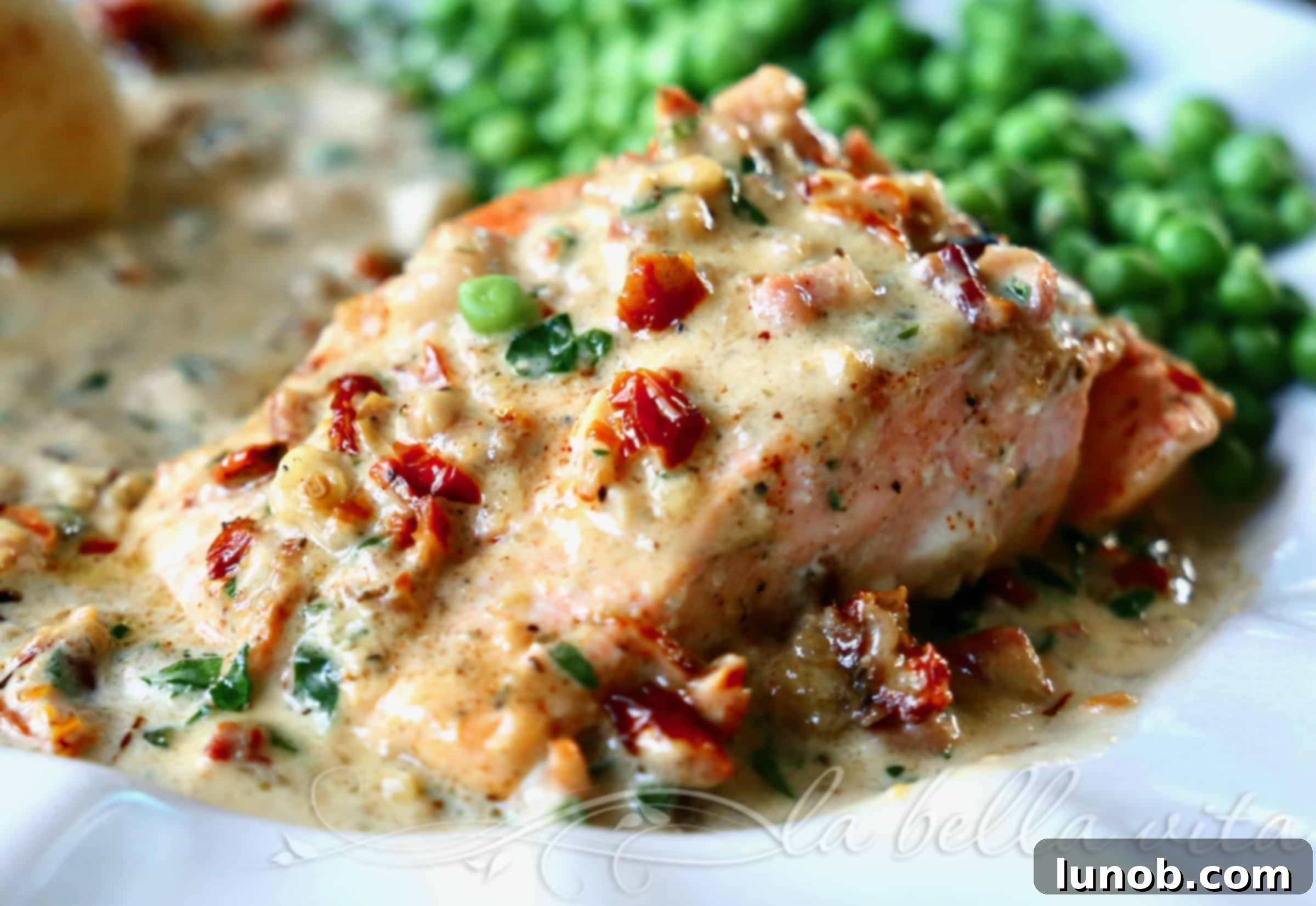 Close-up of creamy Tuscan salmon dish garnished with parsley