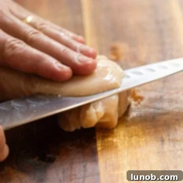 Thinly slicing chicken breast.