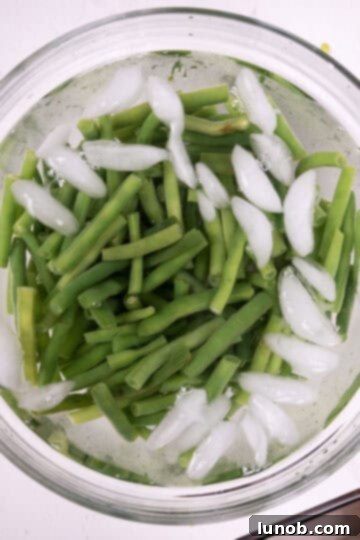 Green beans chilling in an ice bath to stop cooking