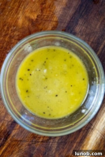 Whisking together the lemon Dijon vinaigrette dressing