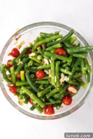 Green beans and cherry tomatoes tossed with the dressing and slivered almonds