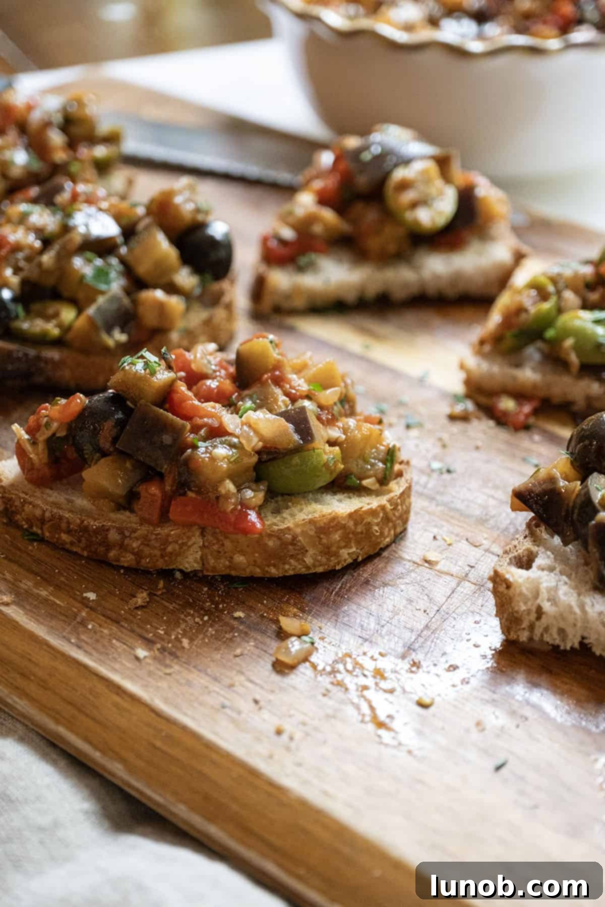A close-up shot of delicious Eggplant Caponata served on crostini