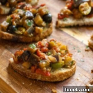 Finished Eggplant Caponata in a white bowl, garnished with fresh parsley