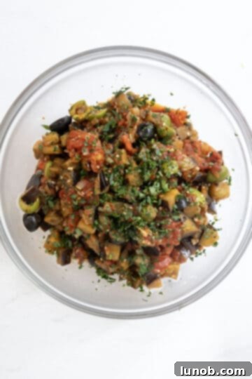 Finished eggplant caponata garnished with fresh chopped parsley