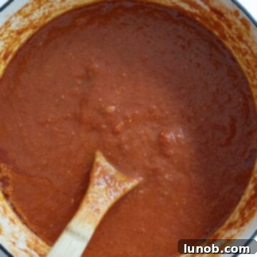 Nonna's Sunday Gravy 11 A large pot of finished Sunday sauce, rich and red, after hours of simmering.