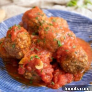 Meatballs covered in tomato sauce in a bowl.