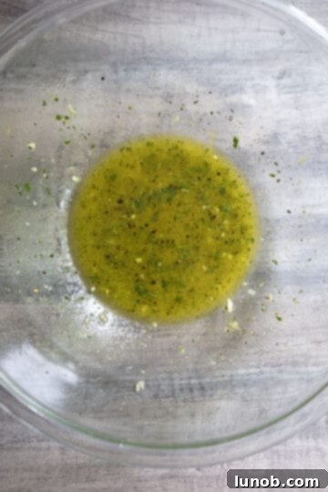 Zesty Grilled Lemon Pepper Chicken Thighs 4 Lemon garlic and parsley marinade mixed in a bowl