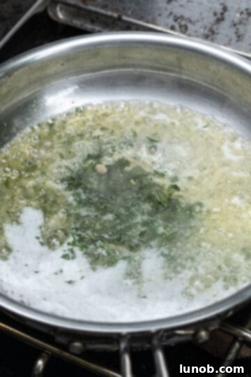 Zesty Grilled Lemon Pepper Chicken Thighs 6 Lemon pepper garlic parsley butter sauce simmering in a small pan