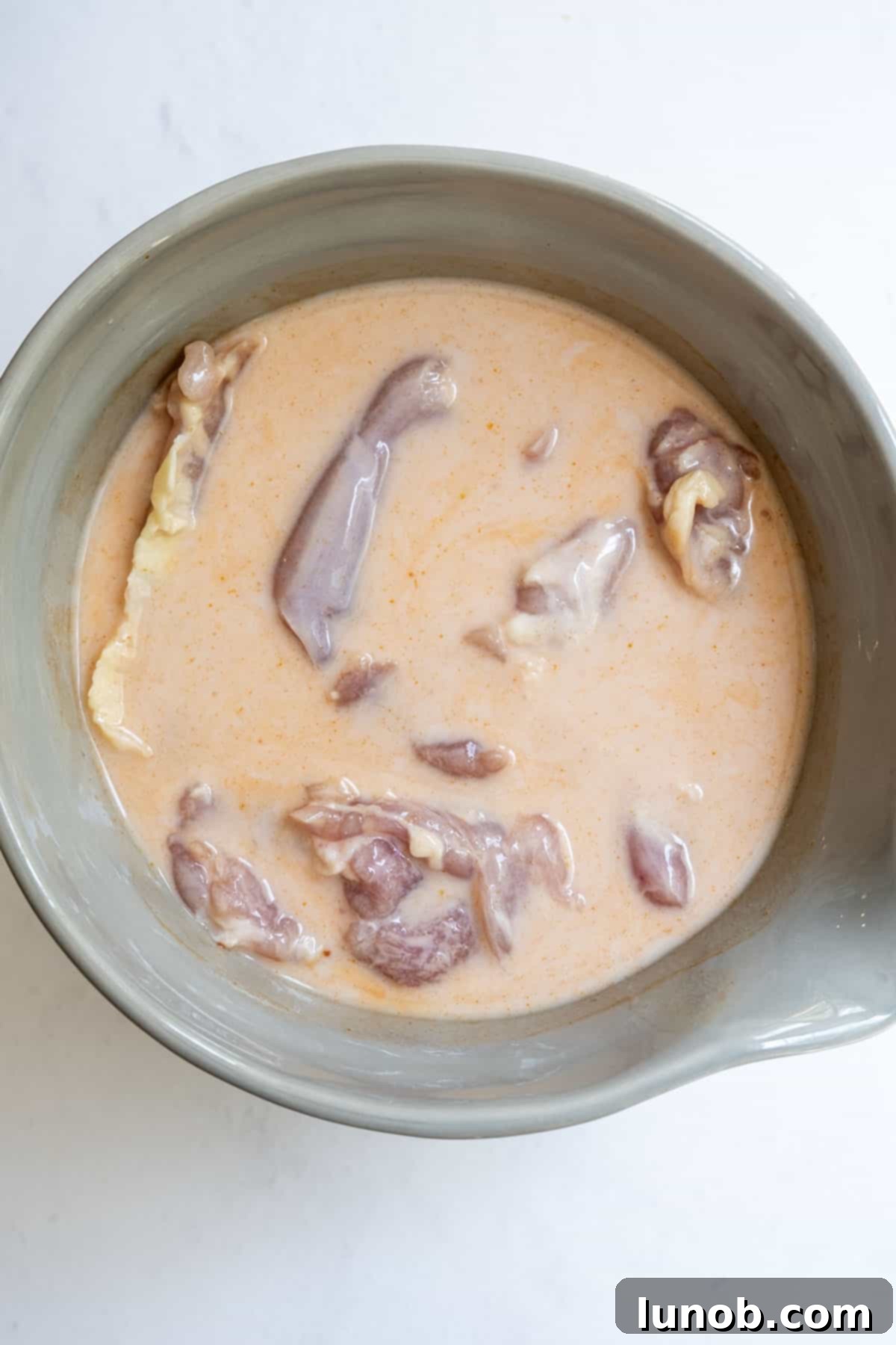 Blazing Honey Chicken Sandwich 4 fried chicken marinating in buttermilk