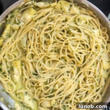 Mediterranean Artichoke Pesto Pasta 9 Artichoke pesto pasta, perfectly combined and creamy, in a large saucepan.